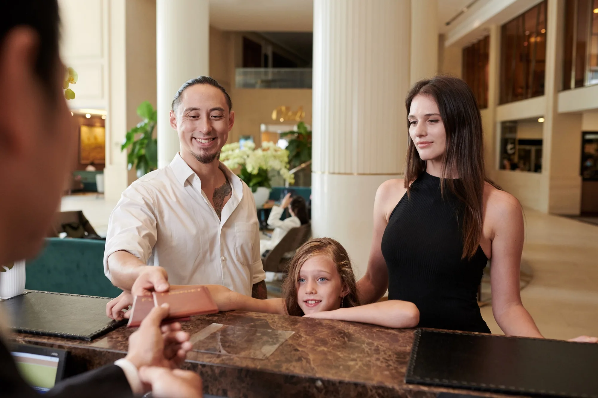 Family Checking in at Hotel Reception