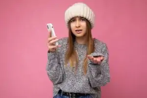 Beautiful angry upset young blonde woman wearing casual grey sweater and beige hat isolated over
