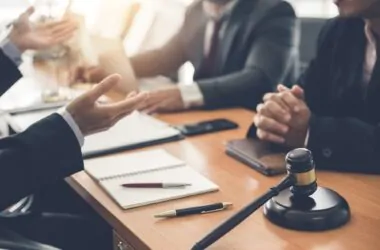 Businessman and lawyer discuss lawsuits in the office.